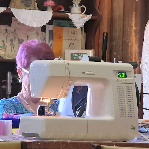 People sewing together at tables